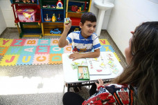 Criança recebendo atendimento com fonoaudióloga na Policlínica Infantil
